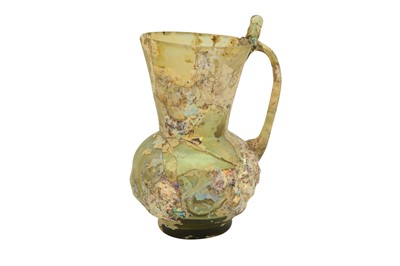 Lot 547 - A MOULD-BLOWN LIGHT GREEN GLASS JUG WITH THUMB REST