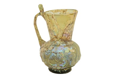 Lot 547 - A MOULD-BLOWN LIGHT GREEN GLASS JUG WITH THUMB REST