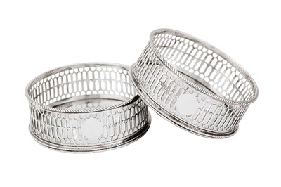 Lot 676 - A pair of George III sterling silver wine coasters, London 1770 by Thomas Nash I