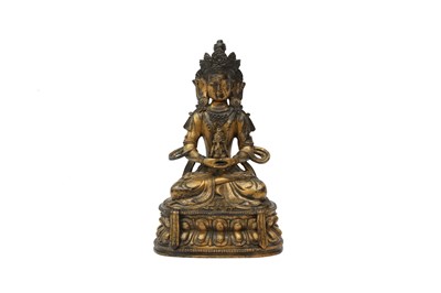 Lot 557 - A SINO-TIBETAN GILT-BRONZE FIGURE OF AMITAYUS