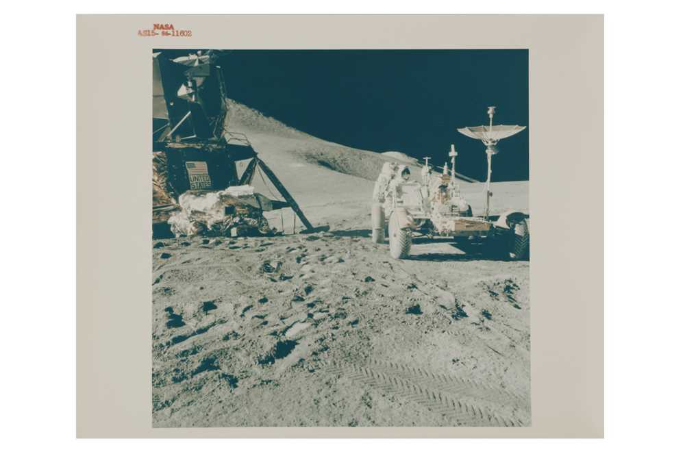 Lot 18 - Apollo 15 Astronaut James B. Irwin, lunar module pilot, works at the Lunar Roving Vehicle (LRV)