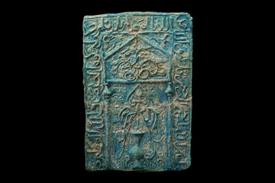 Lot 544 - A LARGE KASHAN MONOCHROME TURQUOISE-GLAZED POTTERY MIHRAB TILE
