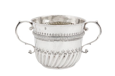 Lot 711 - A Queen Anne Britannia standard silver porringer, London 1702 by Christopher Canner I (reg. April 1697)