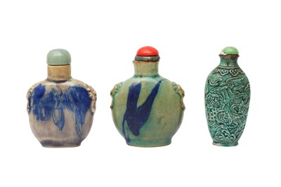 Lot 451 - TWO CHINESE FLAMBÉ-GLAZED SNUFF BOTTLES, TOGETHER WITH A GREEN-GLAZED 'LION DOG' SNUFF BOTTLE