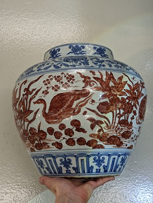 Lot 494 - A CHINESE COPPER RED-ENAMELLED BLUE AND WHITE 'LOTUS POND' JAR