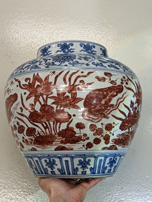 Lot 54 - A CHINESE COPPER RED-ENAMELLED BLUE AND WHITE 'LOTUS POND' JAR
