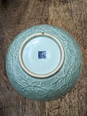 Lot 126 - A CHINESE CELADON-GLAZED 'PEONIES' BOWL