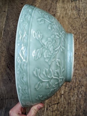 Lot 126 - A CHINESE CELADON-GLAZED 'PEONIES' BOWL