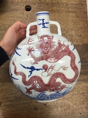 Lot 140 - A CHINESE BLUE AND WHITE AND COPPER-RED 'DRAGON' MOONFLASK, BIANHU