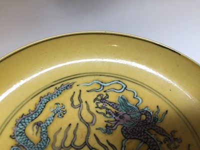 Lot 552 - A CHINESE YELLOW-GROUND 'DRAGON' DISH