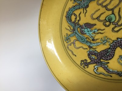 Lot 552 - A CHINESE YELLOW-GROUND 'DRAGON' DISH