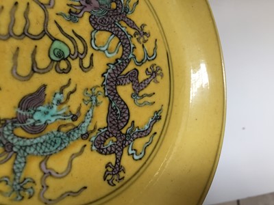 Lot 552 - A CHINESE YELLOW-GROUND 'DRAGON' DISH