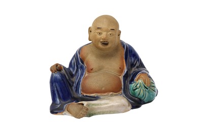 Lot 523 - A CHINESE FIGURE OF A RECLINING BUDAI HESHANG