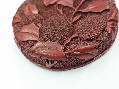Lot 68 - A CHINESE CINNABAR LACQUER 'LYCHEE' CIRCULAR SEAL PASTE BOX AND COVER