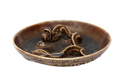 Lot 502 - A CHINESE BROWN-GLAZED MOULDED 'CHILONG' DISH