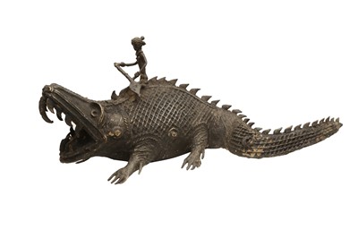 Lot 752 - AN INDIAN BRONZE DHOKRA FIGURE OF A CROCODILE AND RIDER.
