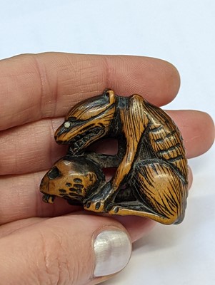 Lot 613 - A JAPANESE WOOD NETSUKE OF A WOLF