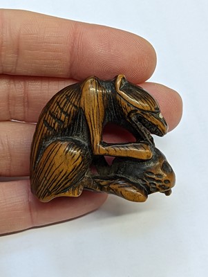 Lot 613 - A JAPANESE WOOD NETSUKE OF A WOLF