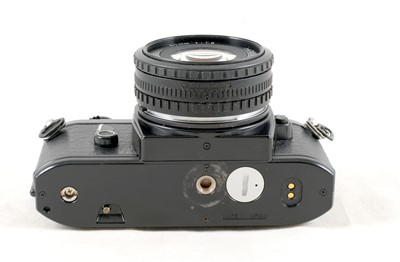 Lot 36 - A Nikon EM 35mm Film SLR with 2 Nikkor Lenses.