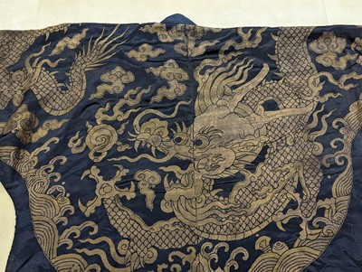 Lot 356 - A CHINESE BLUE-GROUND 'DRAGON' SILK ROBE