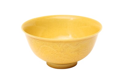 Lot 32 - A CHINESE YELLOW-GLAZED INCISED 'DRAGON' BOWL