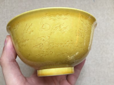 Lot 115 - A CHINESE YELLOW-GLAZED INCISED 'DRAGON' BOWL