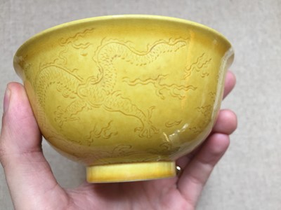 Lot 115 - A CHINESE YELLOW-GLAZED INCISED 'DRAGON' BOWL