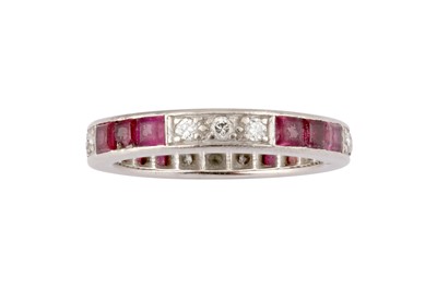 Lot 83 - A ruby and diamond eternity ring