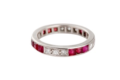 Lot 83 - A ruby and diamond eternity ring