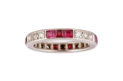 Lot 83 - A ruby and diamond eternity ring