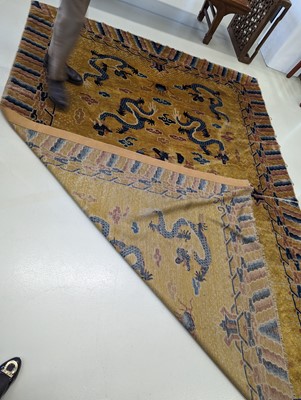 Lot 57 - A RARE CHINESE NINGXIA YELLOW-GROUND 'NINE DRAGON' CARPET