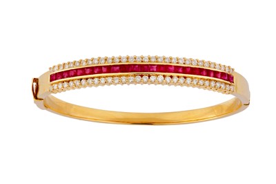 Lot 35 - A ruby and diamond bangle and earclip suite