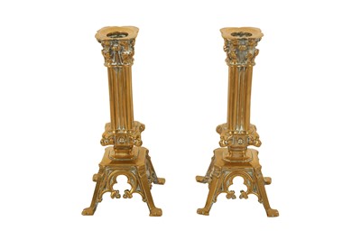 Lot 635 - A PAIR OF 19TH CENTURY ROMANESQUE INSPIRED BRASS CANDLESTICKS