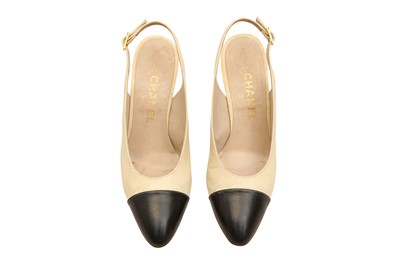 Lot 679 - A PAIR OF CHANEL TWO-TONE SLINGBACK HEELS