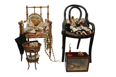 Lot 854 - A SELECTION OF MINIATURE DOLLS ARRANGED ON TWO MODEL CHAIRS OF SMALL PROPORTIONS