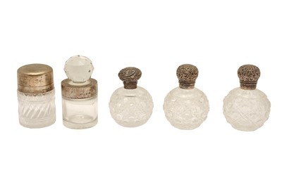 Lot 107 - A GROUP OF FIVE VICTORIAN STERLING SILVER MOUNTED SCENT BOTTLES AND VANITY CREAM JARS