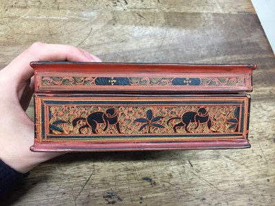 Lot 382 - A BURMESE RED AND BLACK LACQUER 'ELEPHANT' BOX AND COVER