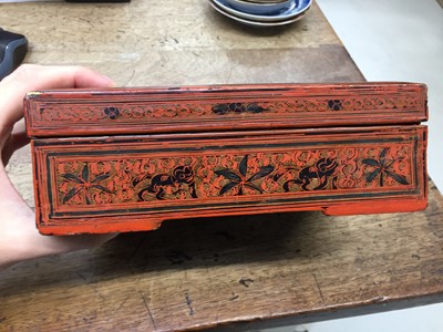 Lot 385 - A BURMESE RED AND BLACK LACQUER 'CHINTHE' BOX