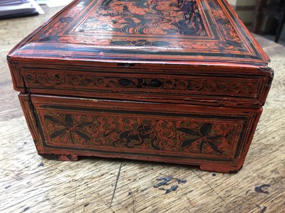Lot 385 - A BURMESE RED AND BLACK LACQUER 'CHINTHE' BOX