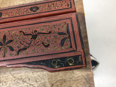 Lot 384 - A LARGE BURMESE RED AND BLACK LACQUER 'ELEPHANTS' BOX AND COVER