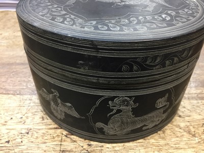 Lot 381 - A BURMESE INCISED BLACK LACQUER 'EQUESTRIAN' BETEL-BOX AND COVER