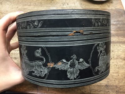 Lot 381 - A BURMESE INCISED BLACK LACQUER 'EQUESTRIAN' BETEL-BOX AND COVER