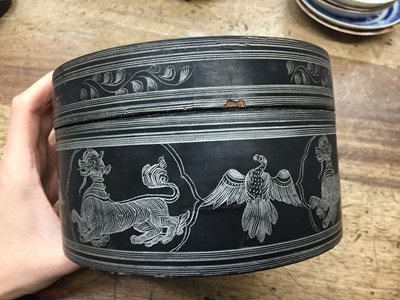 Lot 381 - A BURMESE INCISED BLACK LACQUER 'EQUESTRIAN' BETEL-BOX AND COVER