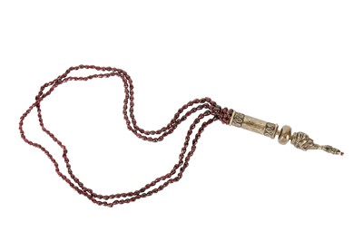 Lot 294 - AN INDIAN NECKLACE WITH GARNET BEADS AND A SILVER LION PENDANT