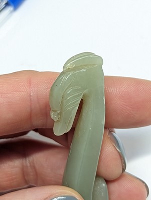 Lot 512 - A GROUP OF TWENTY-TWO CHINESE PALE CELADON JADE CARVINGS