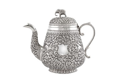 Lot 224 - A late 19th century Anglo – Indian unmarked silver teapot, Cutch circa 1890