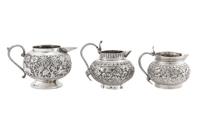 Lot 98 - Three early 20th century Anglo – Indian unmarked silver milk jugs, Lucknow circa 1920