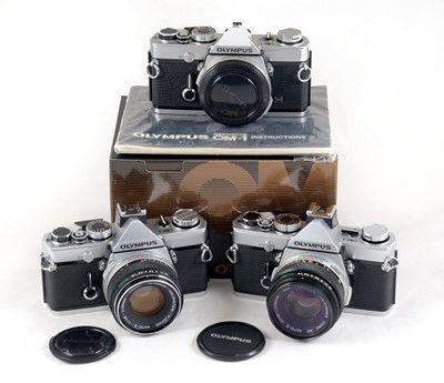 Lot 75 - Three Olympus OM-1 SLR Cameras.
