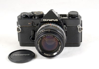 Lot 77 - A Black Bodied Olympus OM-1 with 50mm f1.4 lens