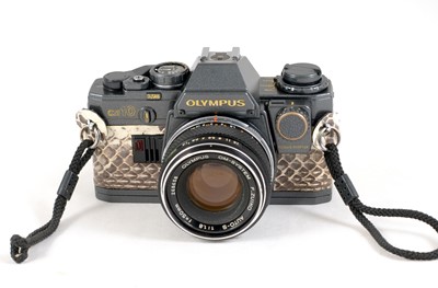 Lot 70 - A "Gun Metal" Olympus OM10 with Snake Skin Style Covering.